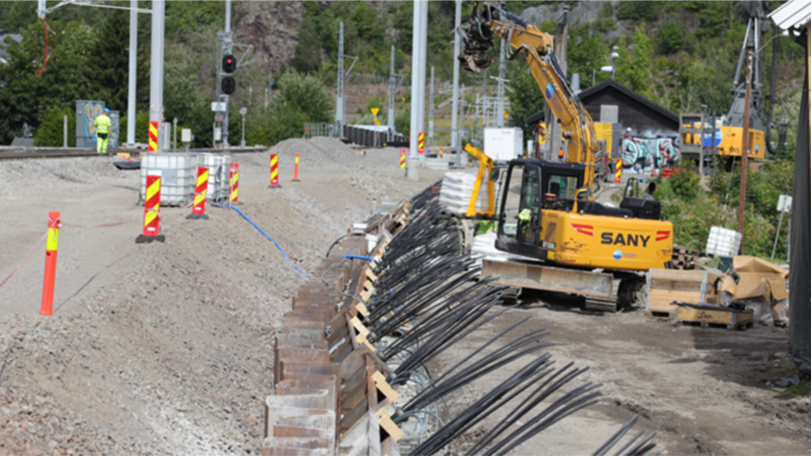 Underbygning på vestre side og spuntarbeid med gravemaskin på høyre.
